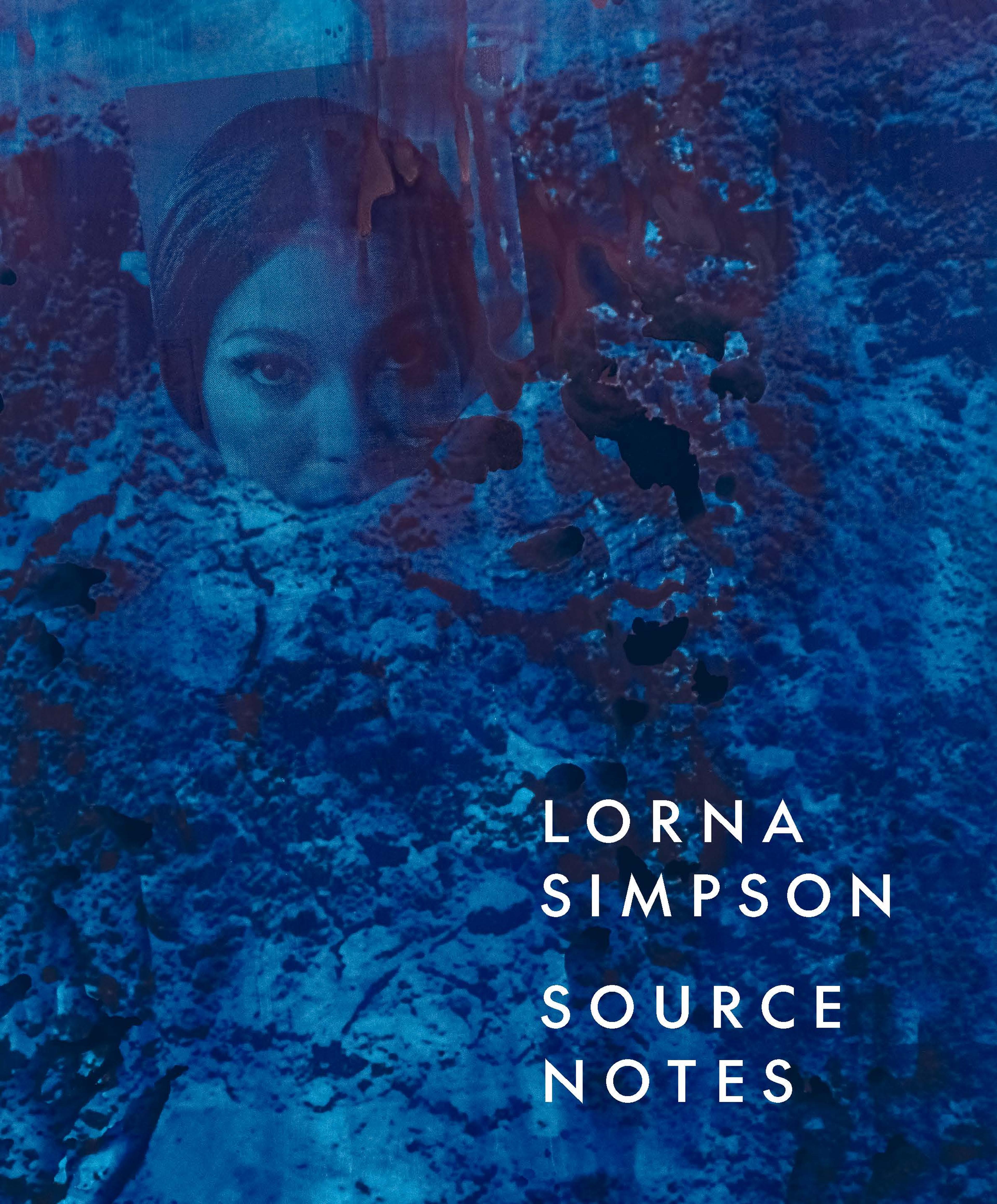 woman with a middle part embedded in a rocky terrain looking straight forward