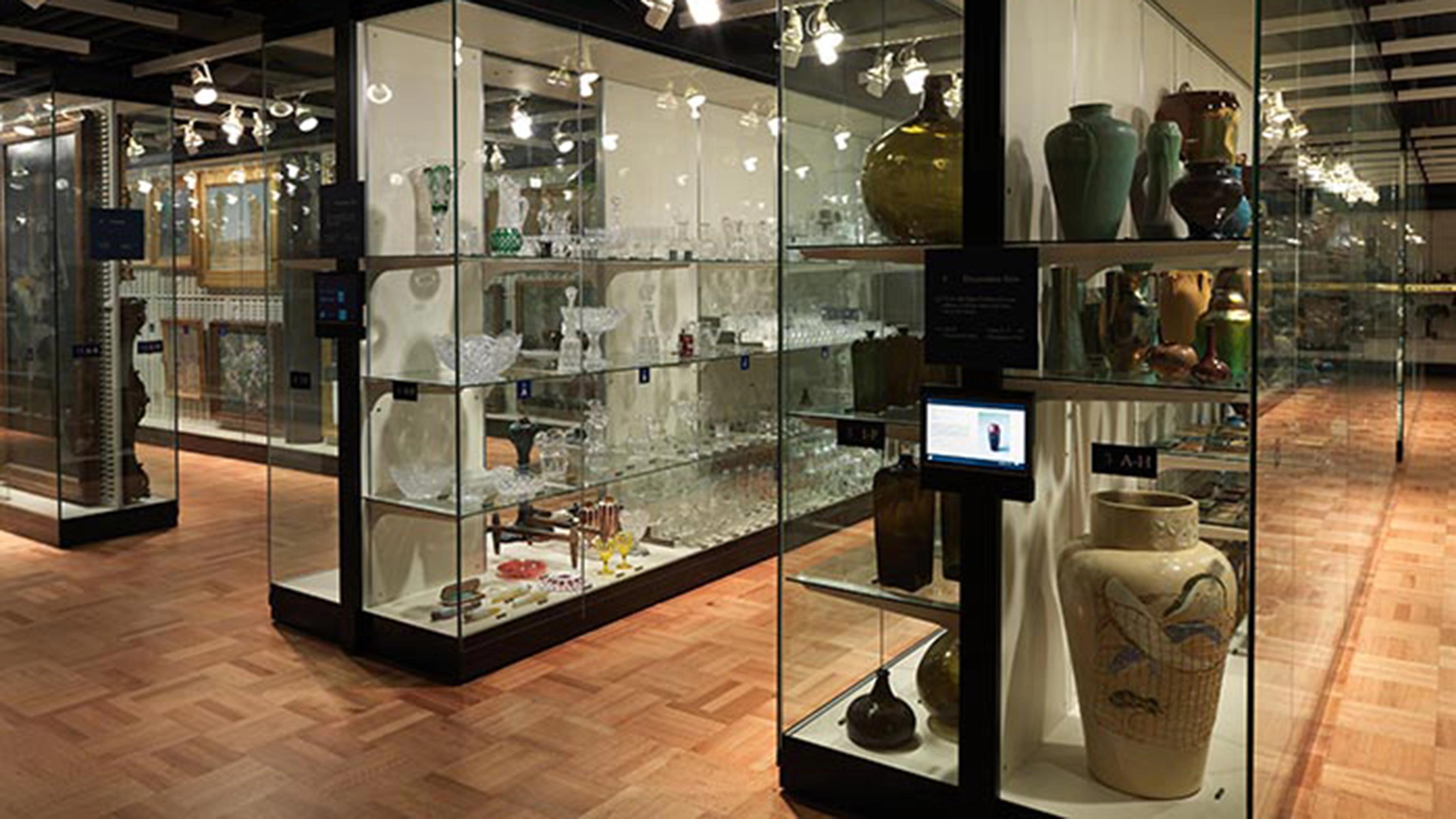 Tall glass display cases showing object storage for the American Wing