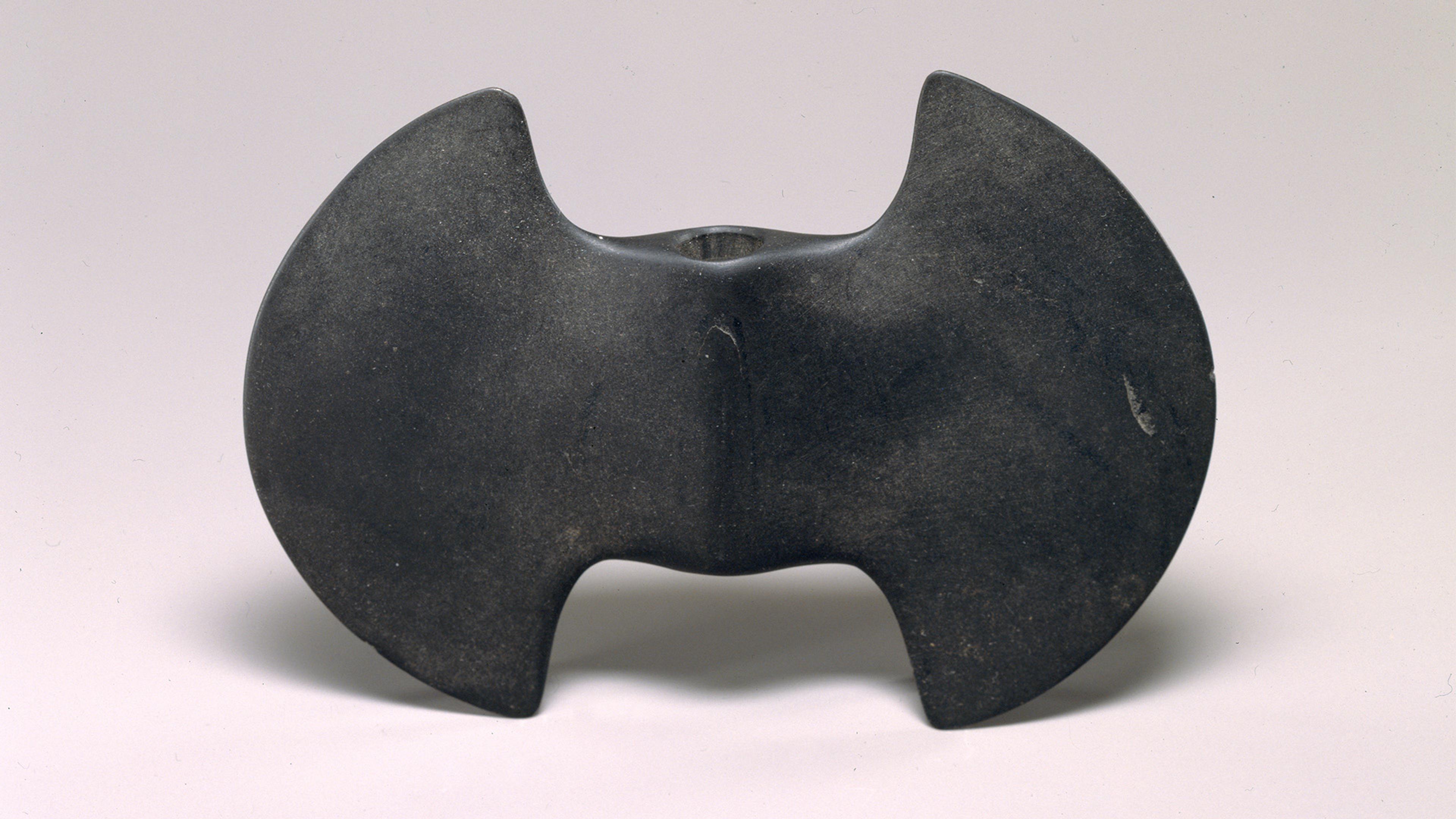 Dark smooth bannerstone carved in the shape of a double-bitted axe